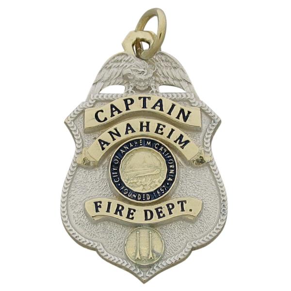 Custom Anaheim CA Fire Captain badge pendant in 10k yellow gold with rhodium plated two tone finish and black and blue enamel.