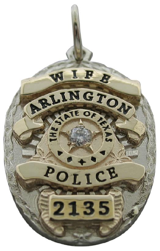 Custom Arlington, Texas Police Officer badge pendant in 10k white gold with 14k yellow gold ribbons, a 0.05 ct. round brilliant diamond, and black enamel text.
