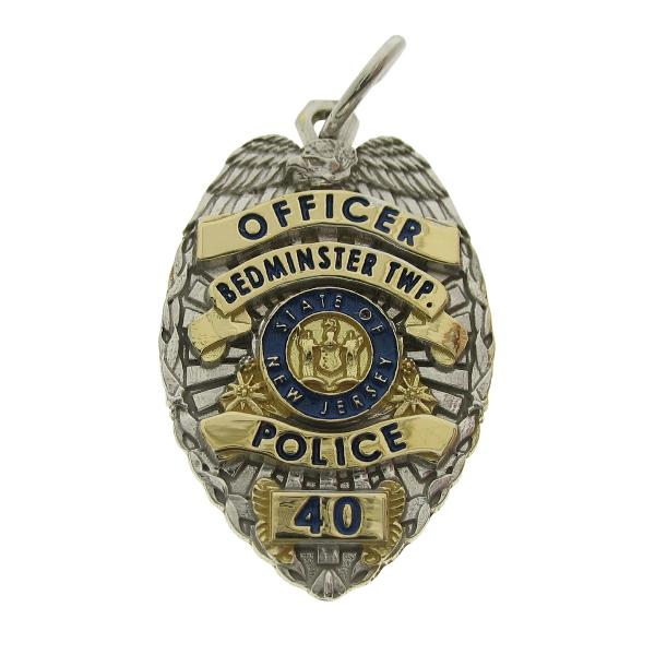 Custom Bedminster Twp. NJ Police Officer badge pendant in 18k two tone with standing center seal bezel and blue enamel.