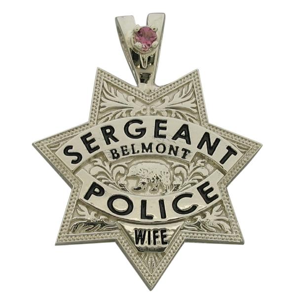 Custom Belmont CA Police Sergeant badge pendant in 10k white gold with a pink birthstone set on a 'Y' bail. Black enamel text.