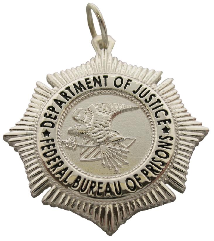 Custom United States Department of Justice Federal Bureau of Prisons Officer badge pendant in sterling silver with black enamel.