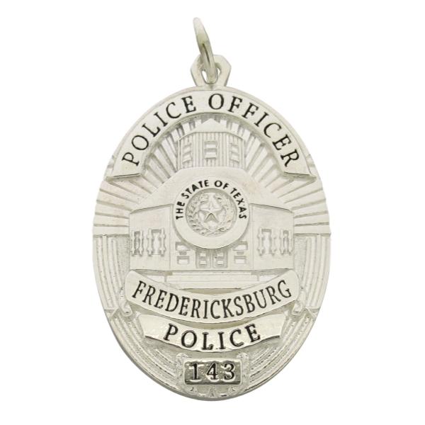 Custom Fredericksburg TX Police Officer badge pendant in sterling silver with black enamel.