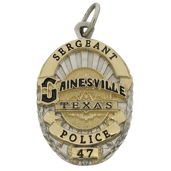 Custom Gainesville TX Police Officer badge pendant in 14k yellow gold with rhodium plated two tone finish and black enamel.