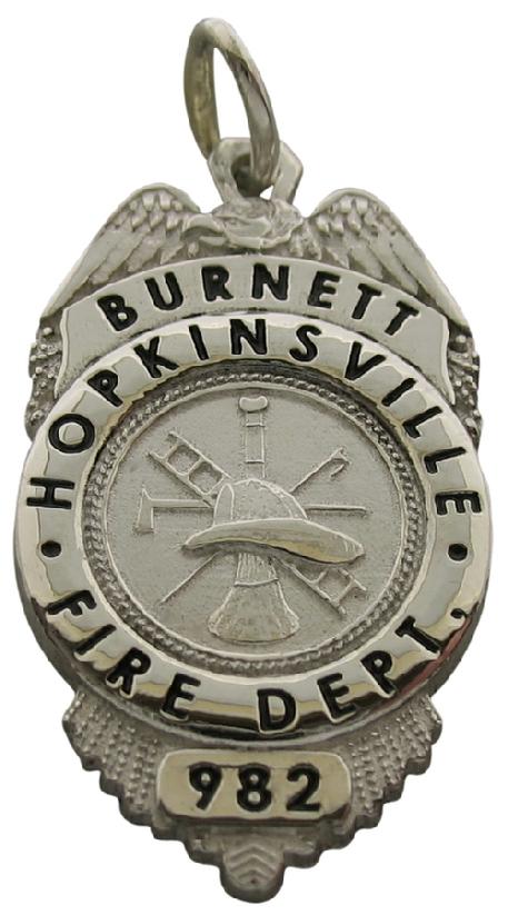 Custom Hopkinsville KY Firefighter badge pendant in sterling silver with fire scramble center and black enamel.