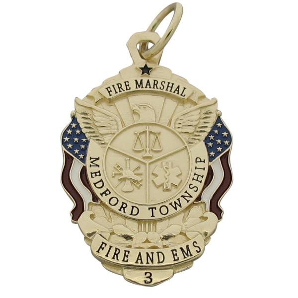 Custom Medford Township NJ Fire Marshal badge pendant in 14k yellow gold with red, white, and blue enamel flags and black enamel text.