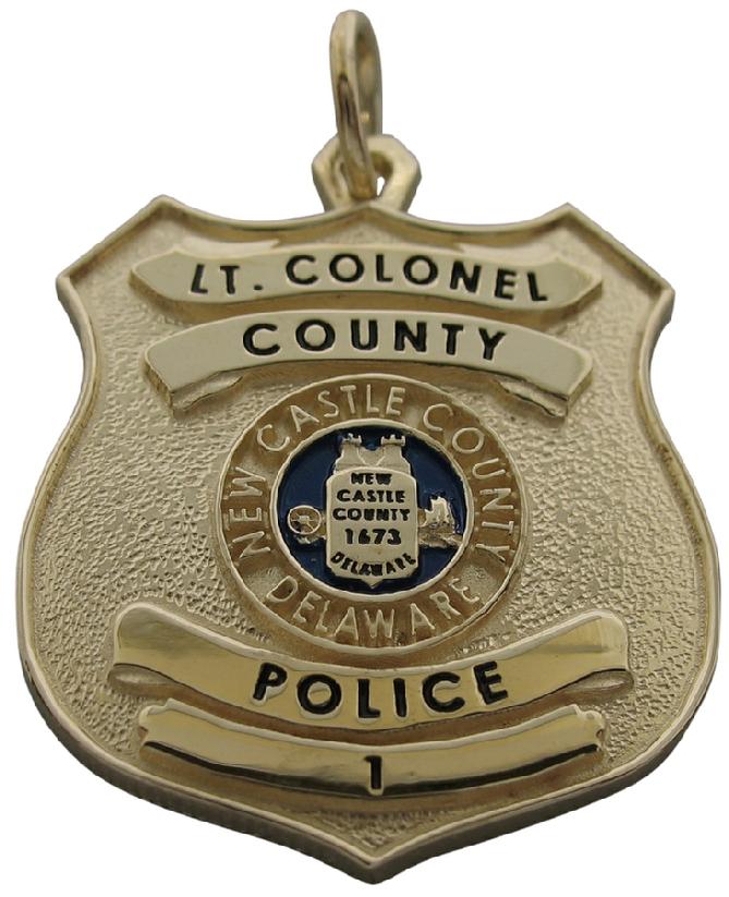 Custom New Castle DE Police Lt. Colonel badge pendant in 14k yellow gold with standing letter detail, blue enamel background, and black enamel text.