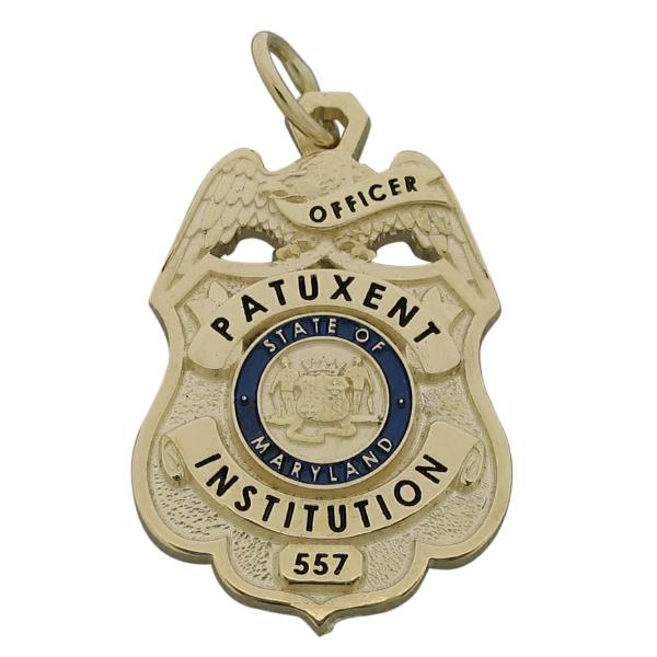 Custom Patuxent Institution Officer badge pendant in 10k yellow gold with standing letter seal bezel and blue and black enamel.