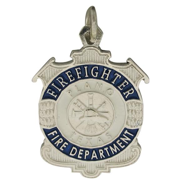 Custom Plano TX Firefighter badge pendant in sterling silver with raised letter detail and blue enamel.