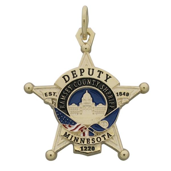 Custom Ramsey MN Sheriff's Deputy badge pendant in 10k yellow gold with red, white, black, and blue enamel and standing letter detail.