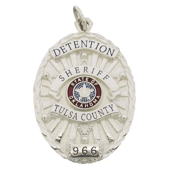 Custom Tulsa OK Sheriff Detention Officer badge pendant in sterling silver with blue and red enamel.