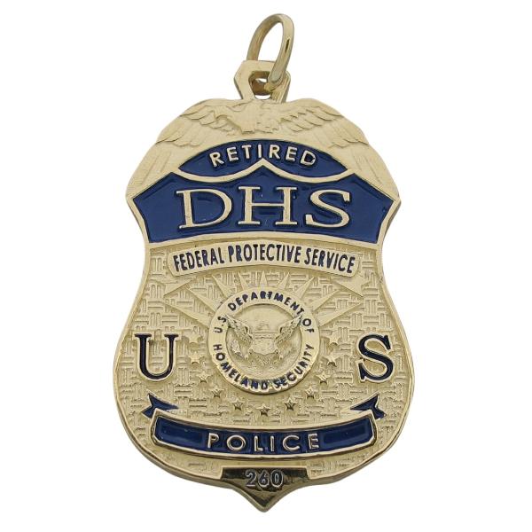 Custom U.S. DHS badge pendant in 10k yellow gold with raised letter detail and blue enamel.