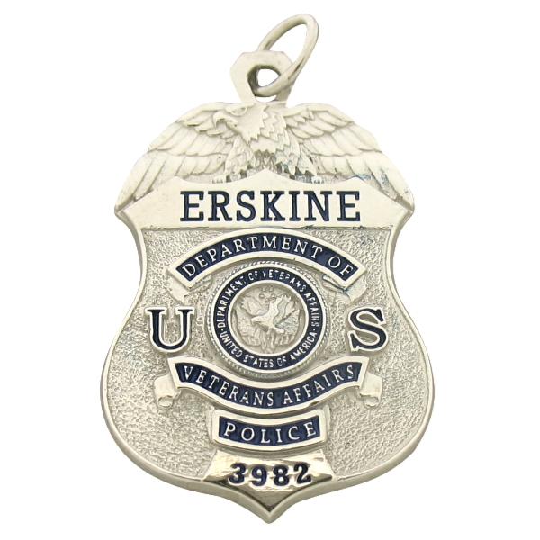Custom United States Department of Veterans Affairs Police Officer badge pendant in 10k white gold with blue enamel highlights and engraved badge number.