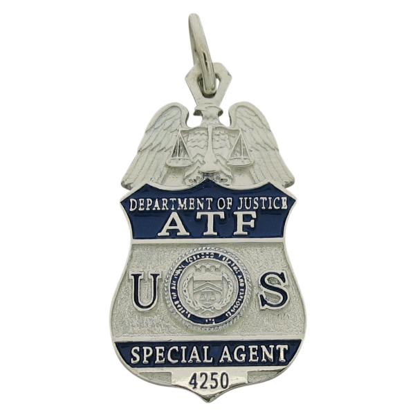 Custom U.S. Department of Justice ATF Special Agent badge pendant in sterling silver with blue enamel.