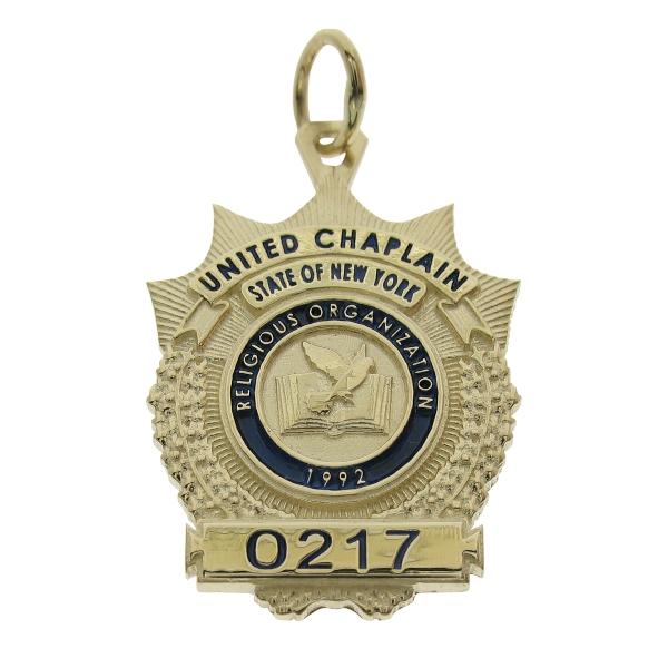 Custom United Chaplain NY badge pendant in 10k yellow gold with standing letter detail and blue enamel.