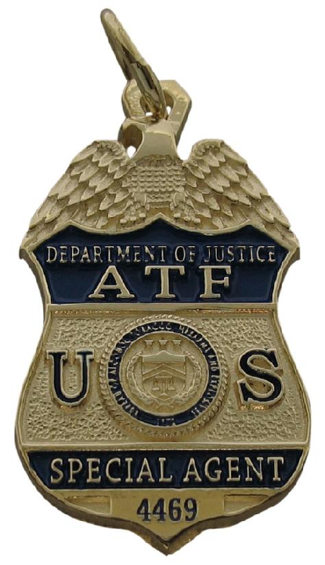 Custom United State Bureau of Alcohol, Tobacco, and Firearms Special Agent badge pendant in 10k yellow gold with standing letter detail and blue enamel background and text.